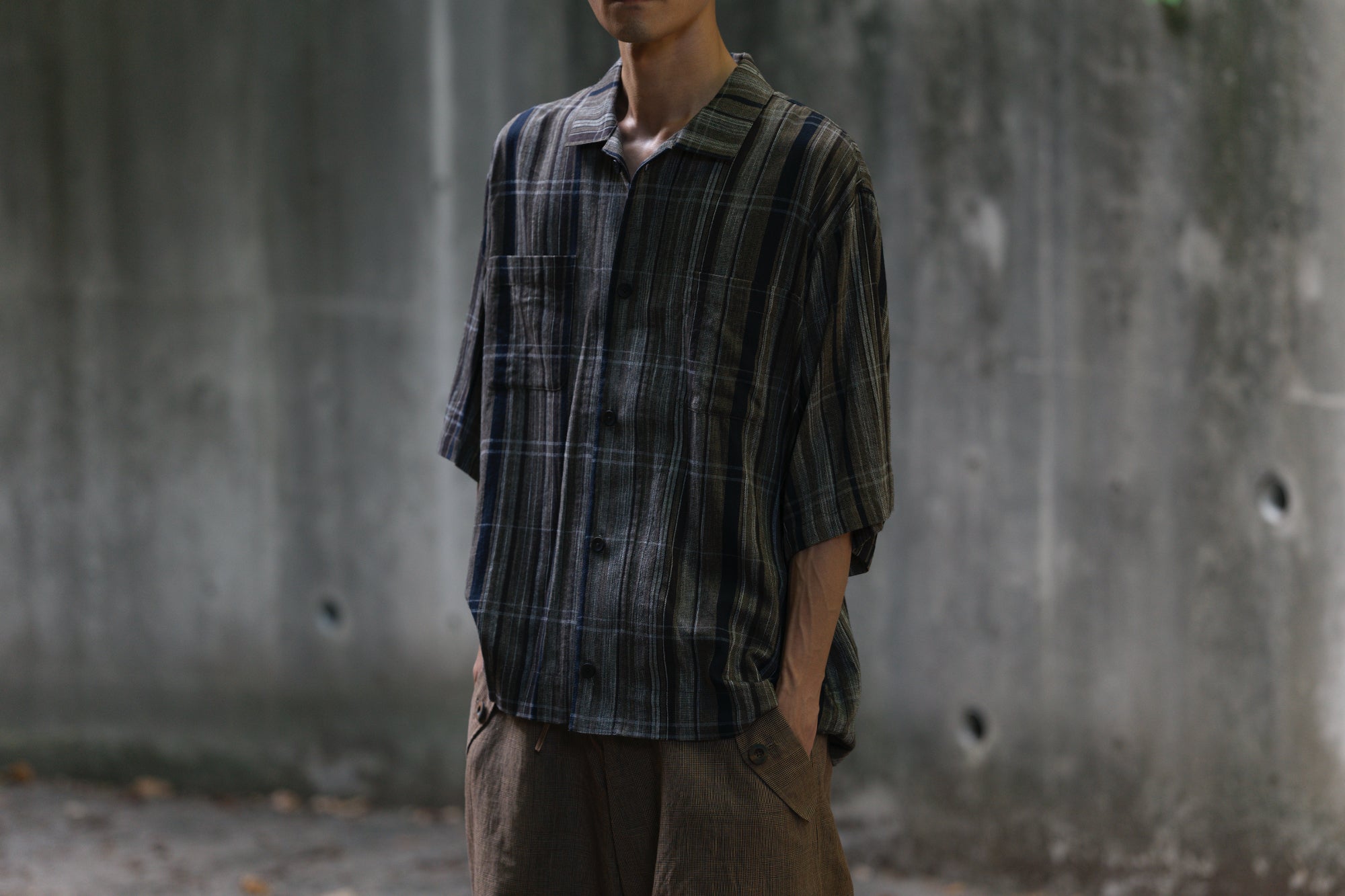 Styling detail with a dark striped short-sleeve shirt